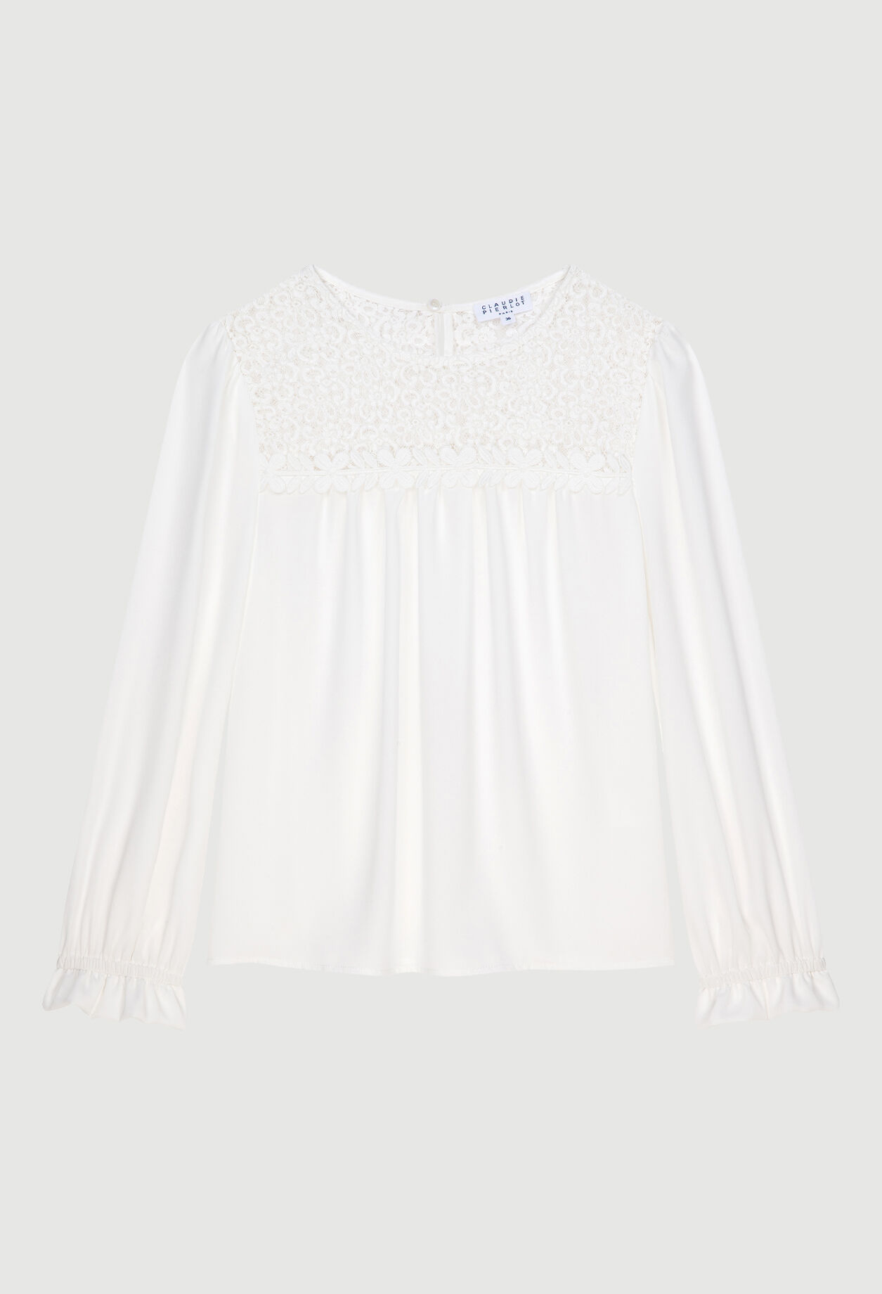 Blouse à détails guipures.